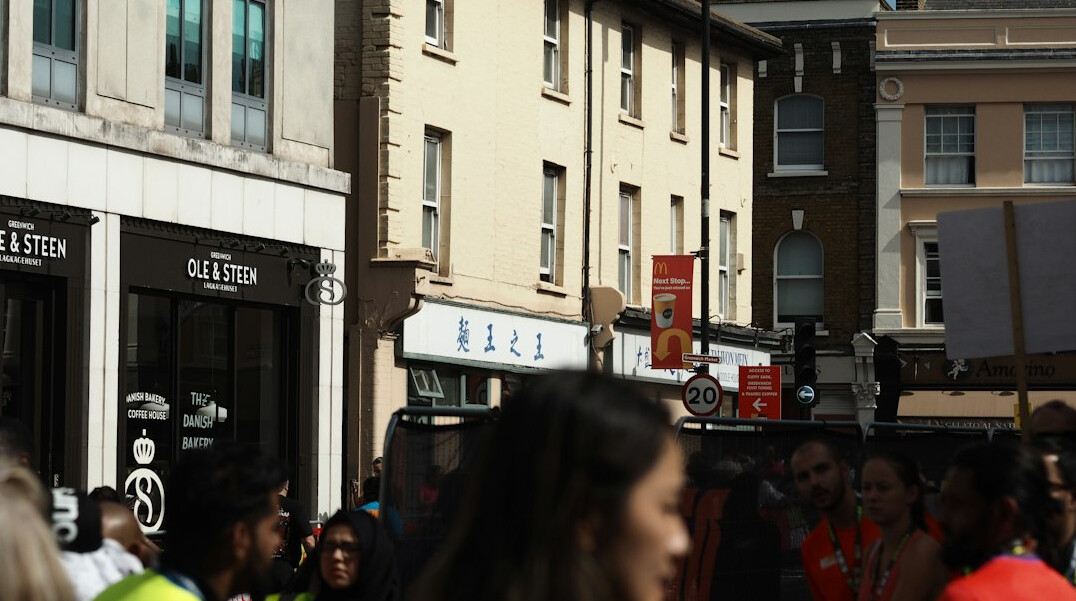 Customers waiting in line outside a Danish bakery before opening
