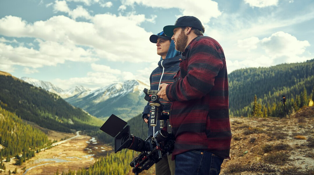 Portrait of two documentary photographers standing together outdoors