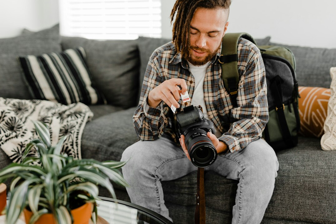 Portrait of a documentary photographer reviewing photos on a laptop