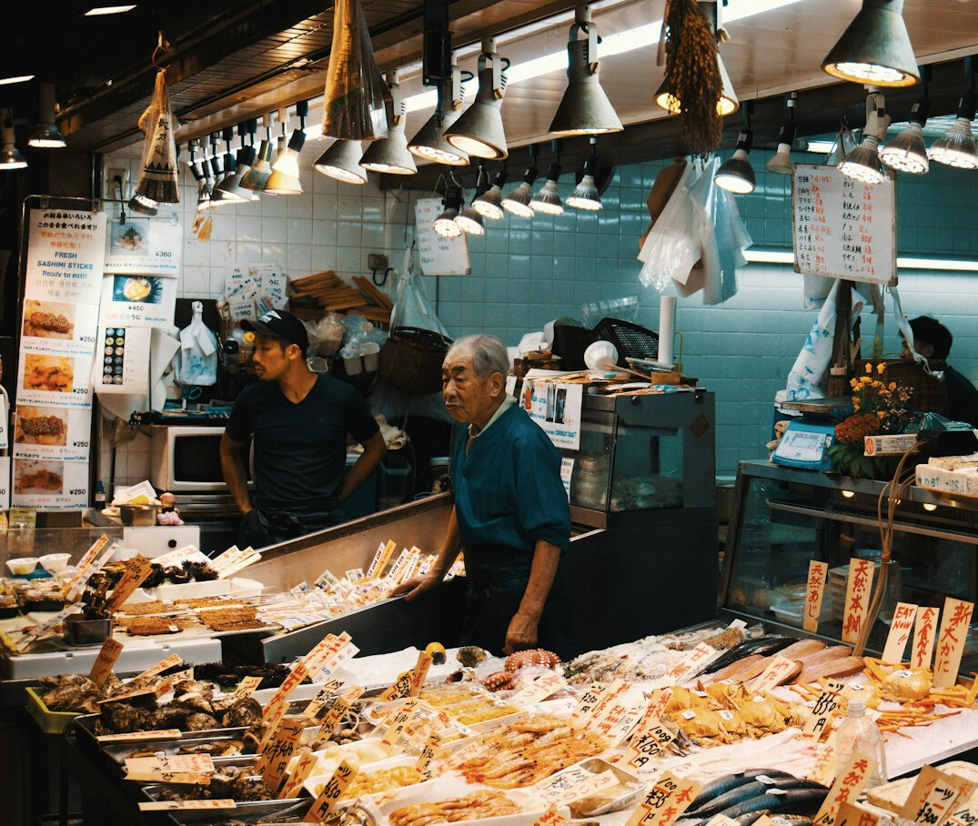 A Danish fishmonger serving a customer at a harbor stall