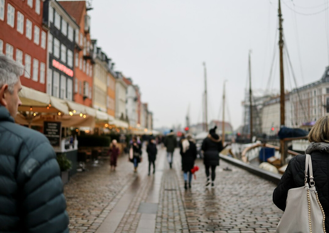 Street photographer documenting a queue in Copenhagen